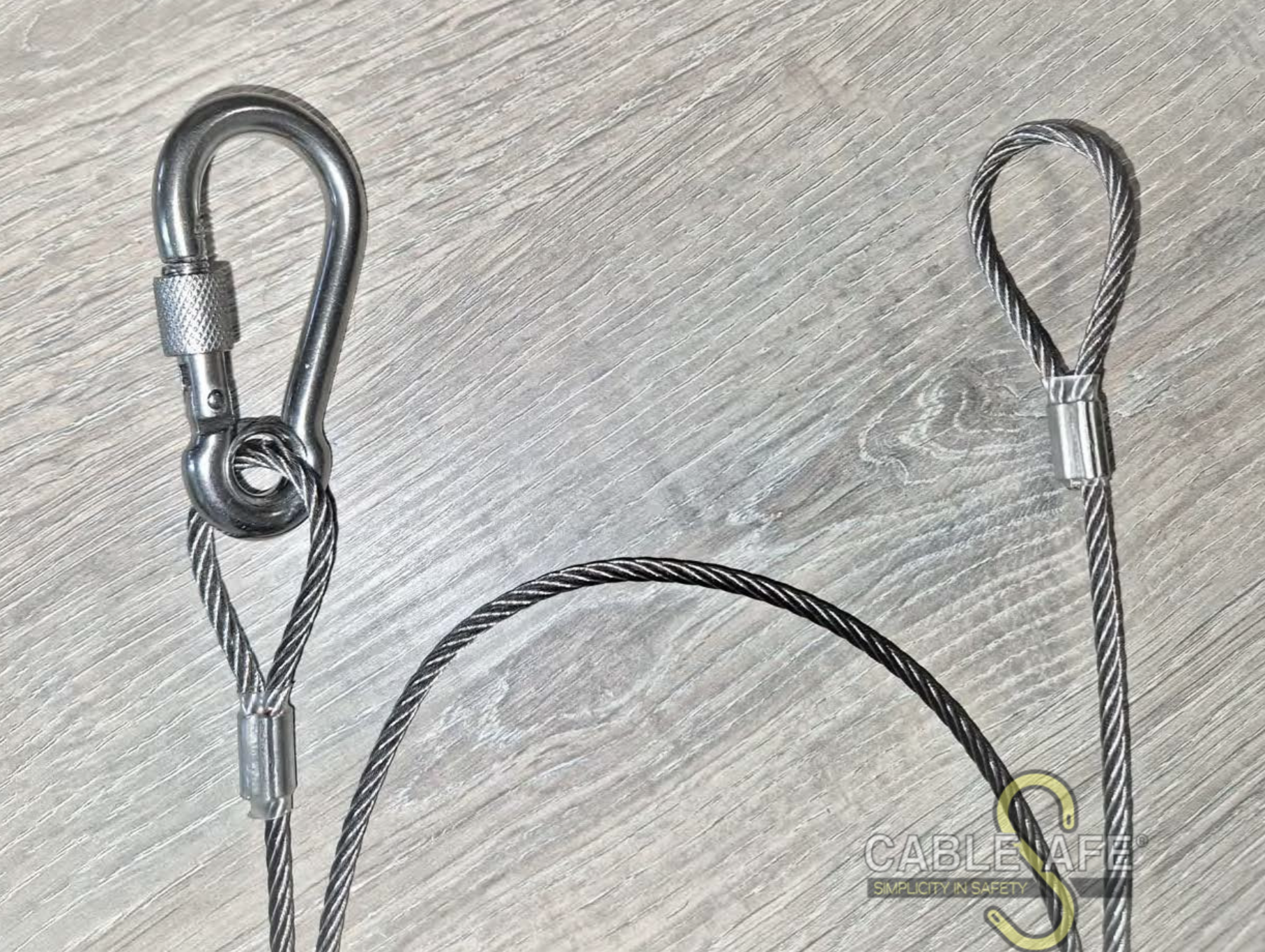 Steel securing lanyards with dual action carabiner